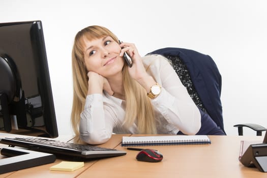 young beautiful business woman sitting at office desk working, isolated on white background