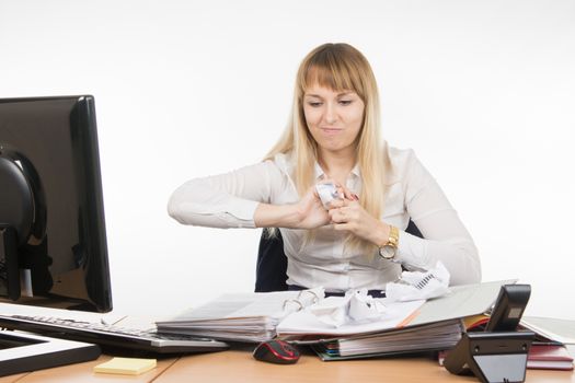 young beautiful business woman sitting at office desk working, isolated on white background