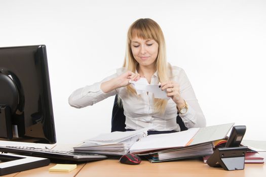 young beautiful business woman sitting at office desk working, isolated on white background