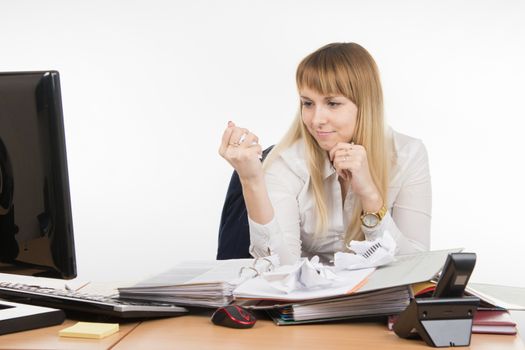young beautiful business woman sitting at office desk working, isolated on white background