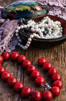 coral beads strewn with autumn leaves