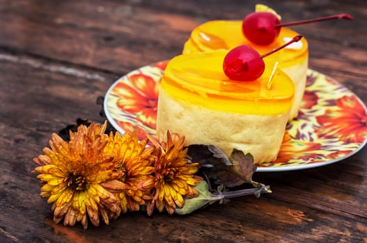 round cake covered with quince jam on wooden texture