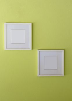 Blank white picture frame on limegreen wall