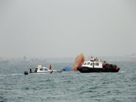 SINGAPORE STRAIGHT: Rescue ships on the scene of the freighter sinking on December 17, 2015 in the Singapore Straight. The freighter sunk after colliding with another ship.Six crew members were rescued by the Singapore Police Coast Guard and Maritime and Port Authority of Singapore, but six crew members remain missing as search efforts continue.