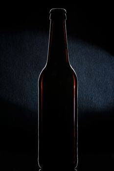 beer bottle brown balck background spot