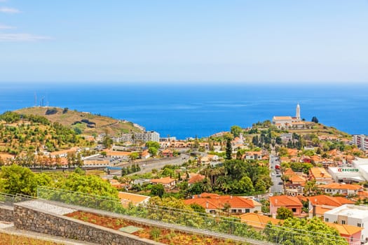 Funchal, Madeira - June 7, 2013: South coast of Funchal -view over the capital city of Madeira, district Sao Martinho with civila parish church. View from Pico dos Barcelo - Atlantic Ocean in the background.