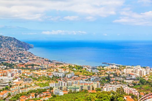 Funchal, Madeira - June 7, 2013: South coast of Funchal -view over the capital city of Madeira towards harbor. View from Pico dos Barcelo - Atlantic Ocean in the background.