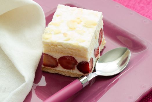 Dessert - sweet strawberry cake on pink plate and white napkin