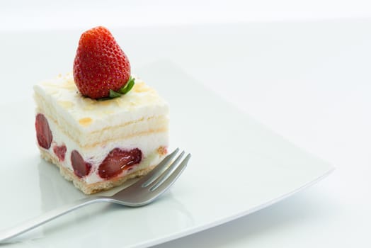 Dessert - sweet strawberry cake on white plate