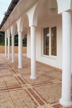 White columns in front of the house.