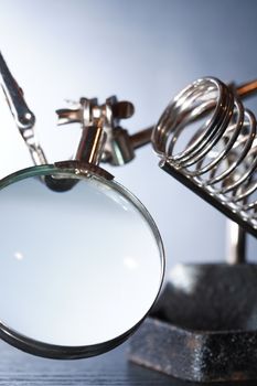 Laboratory equipment. Vintage metal appliance with holders and magnifying glass