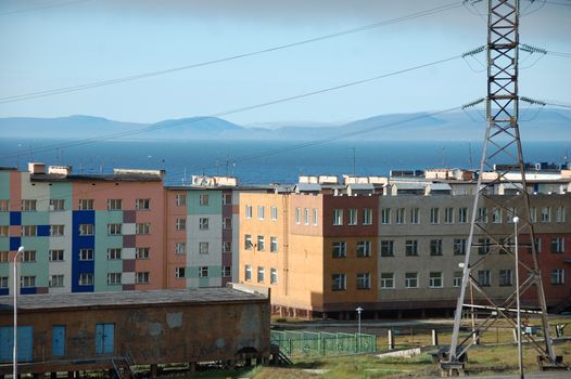 Apartment building block with hilly tundra coast in background, Pevek town, Chukotka, Russia