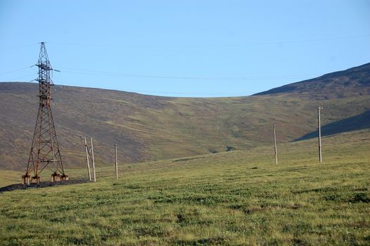 Electric cable line at tundra near Pevek town, Chukotka, Russia