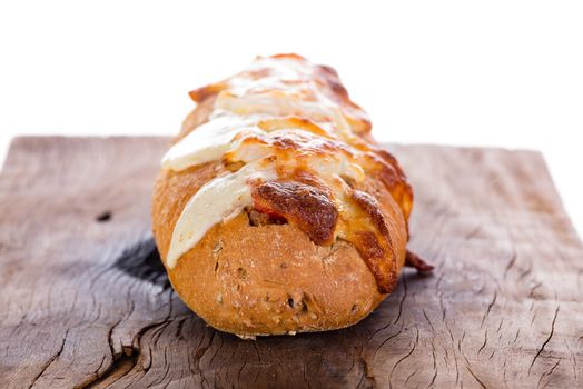 pizza baguette with mozzarella onion and tuna decorated with basil leafs