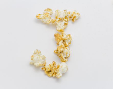pop corn forming letter J isolated on white background