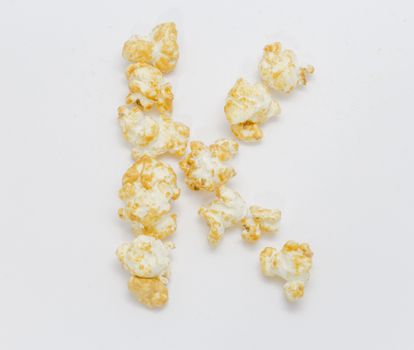 pop corn forming letter K isolated on white background