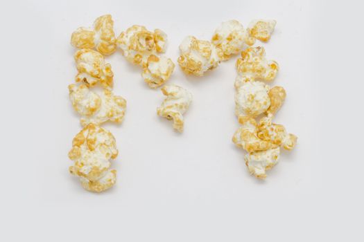 pop corn forming letter M isolated on white background