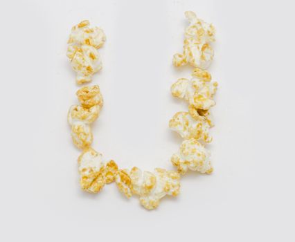 pop corn forming letter U isolated on white background