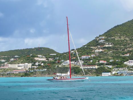 Great Bay, St. Maarten, Netherlands Antilles-June 22, 2013: Former America's Cup yacht, Canada 2, picks up wind and gives the the tourists and crew a thrilling cruise off the coast.