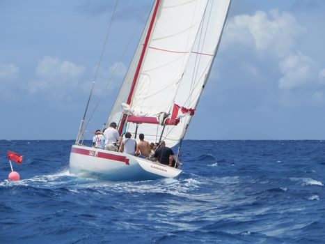 Great Bay, St. Maarten, Netherlands Antilles-June 22, 2013: Former America's Cup yacht, Canada 2, picks up wind and gives the the tourists and crew a thrilling cruise off the coast.