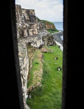 A opening in the guardhouse at the old fort in San Juan, Puerto Rico. Soldiers can hide behind the walls and fire through the slot at any attackers.