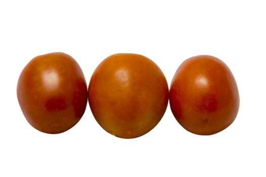 three fresh tomatoes with green leaves isolated on white background