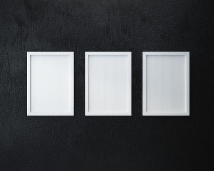 3 Blank frame on  black wall.