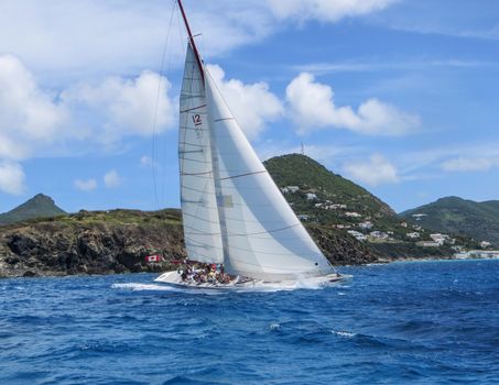 Great Bay, St. Maarten, Netherlands Antilles-June 22, 2013: Former America's Cup yacht, Canada 2, picks up wind and gives the the tourists and crew a thrilling cruise off the coast.