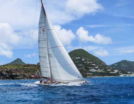 Great Bay, St. Maarten, Netherlands Antilles-June 22, 2013: Former America's Cup yacht, Canada 2, picks up wind and gives the the tourists and crew a thrilling cruise off the coast.