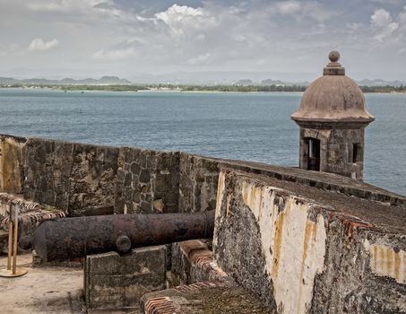 A old rusty cannon stands watch at the old Spanish fort of Castillo San Felipe del Morro in San Juan, Puerto Rico.
