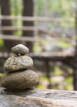 Zen stone with bamboo bridge on background