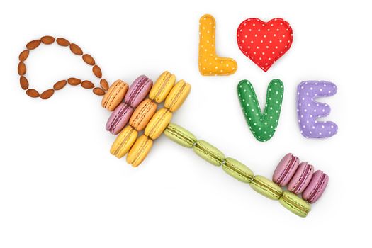 Macarons sweet colorful, key shape. Word Love handmade, heart. French traditional delicious dessert, almond. Unusual creative romantic still life. Concept for love story. Valentines Day. Isolated