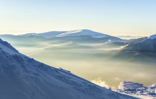 Winter view of the mountain in the sunlight. Dusk. Clear sky. Snowy hill