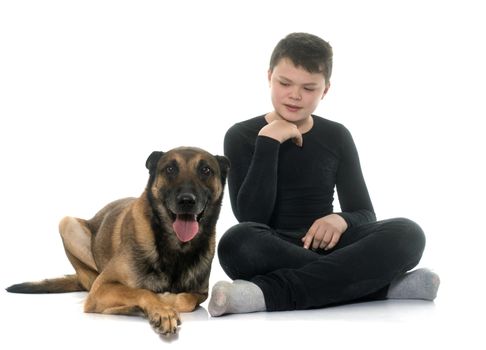 young teen and malinois in front of white background