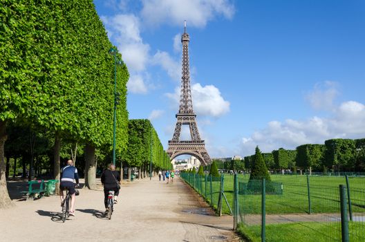 Paris, France - May 15, 2015: Parisian people visit the Champs de Mars, at the foot of the Eiffel Tower in Paris. on May 15, 2015.