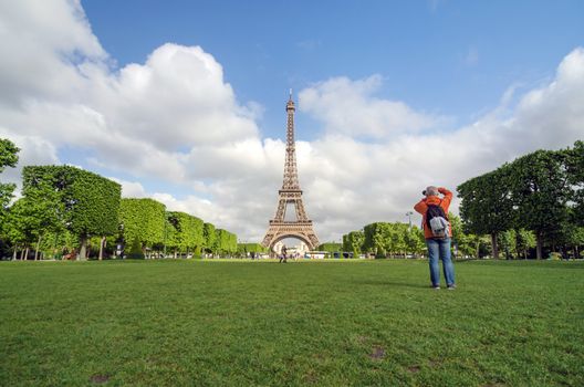 Paris, France - May 15, 2015: People visit the Champs de Mars, at the foot of the Eiffel Tower in Paris. on May 15, 2015.