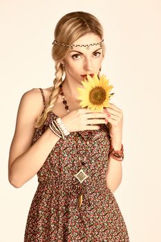 Hippie boho woman with sunflower. Beauty young playful positive blonde, pigtails, ethnic accessories relax. Floral sundress, romantic style.Attractive loving girl. Unusual creative, people,copyspace