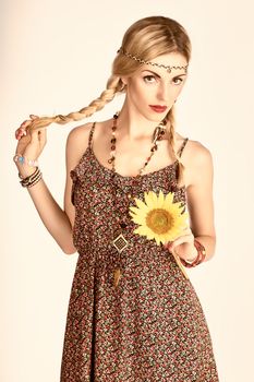 Hippie boho woman with sunflower. Beauty young playful positive blonde, pigtails, ethnic accessories relax. Floral sundress, romantic style.Attractive loving girl. Unusual creative, people,copyspace