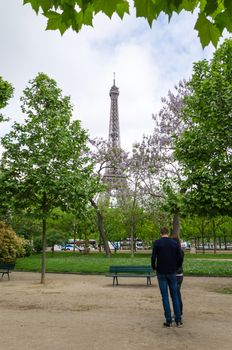 Paris, France - May 15, 2015: People at the Champs de Mars, at the foot of the Eiffel Tower in Paris. on May 15, 2015.