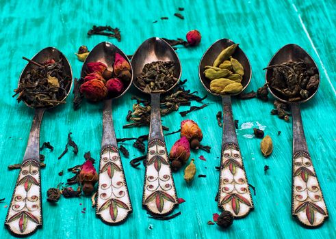 range of different varieties of tea leaves on wooden background