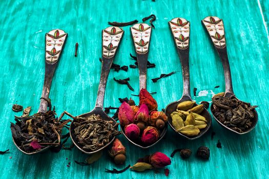 range of different varieties of tea leaves on wooden background