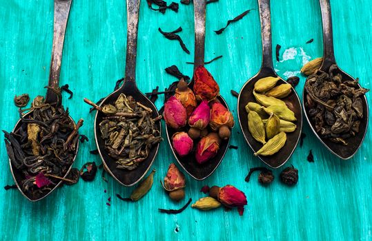 range of different varieties of tea leaves on wooden background