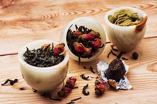 range of different varieties of tea leaves on wooden background