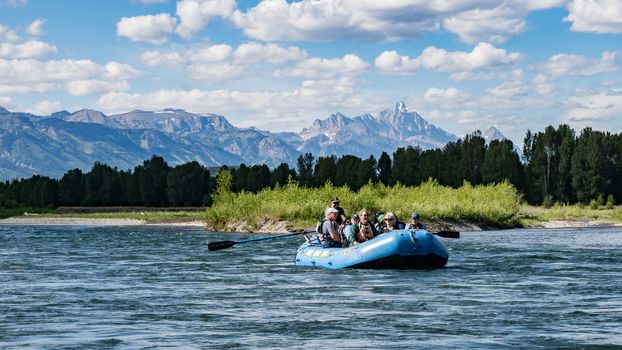 Rafting the Snake River in Wyoming with the Tetons in the distance.