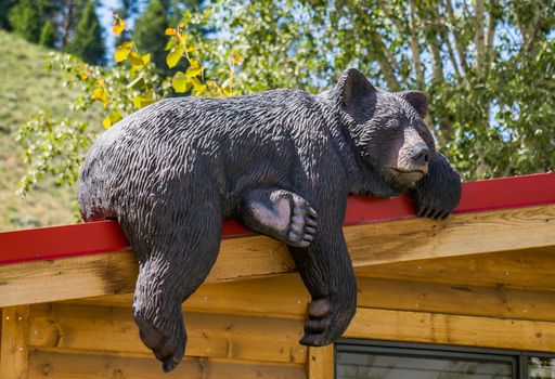 Carving of a sleeping black bear on a cabin in Jackson, Wyoming.