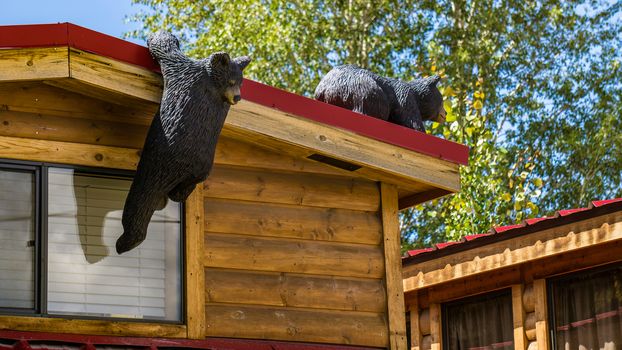 Carving of curious black bears on a cabin in Jackson, Wyoming.