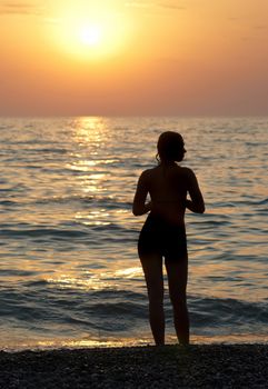 Girl silhouette and sunset on the sea