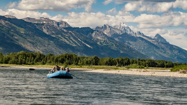 Rafting the Snake River in Wyoming with the Tetons in the distance.