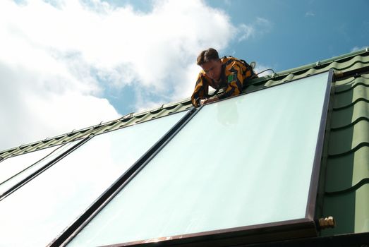 Erector of solar water heating system on the roof.