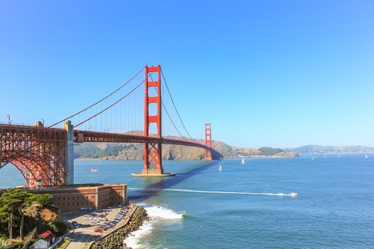 Golden Gate bridge at San Francisco with the clear sky and sailing boat.
